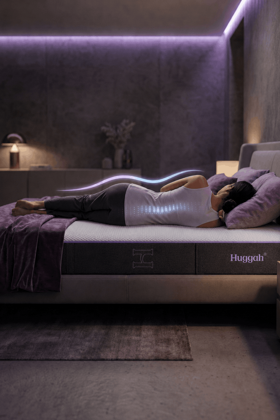 Person lying on a Huggah mattress in a dimly lit bedroom.